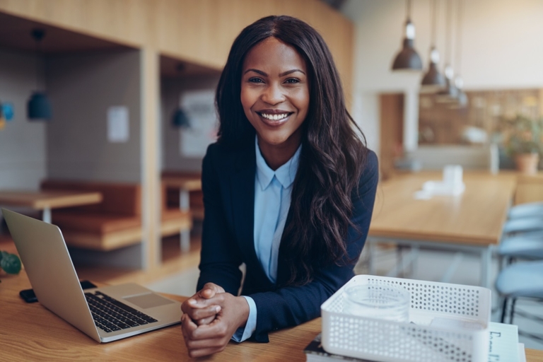 Smiling young African American businesswoman working in an offic – NK&A ...